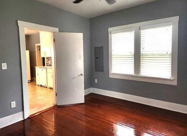 2719 NW 14th St, Oklahoma City, OK 73107 - empty room featuring electric panel, a ceiling fan, and wood finished floors