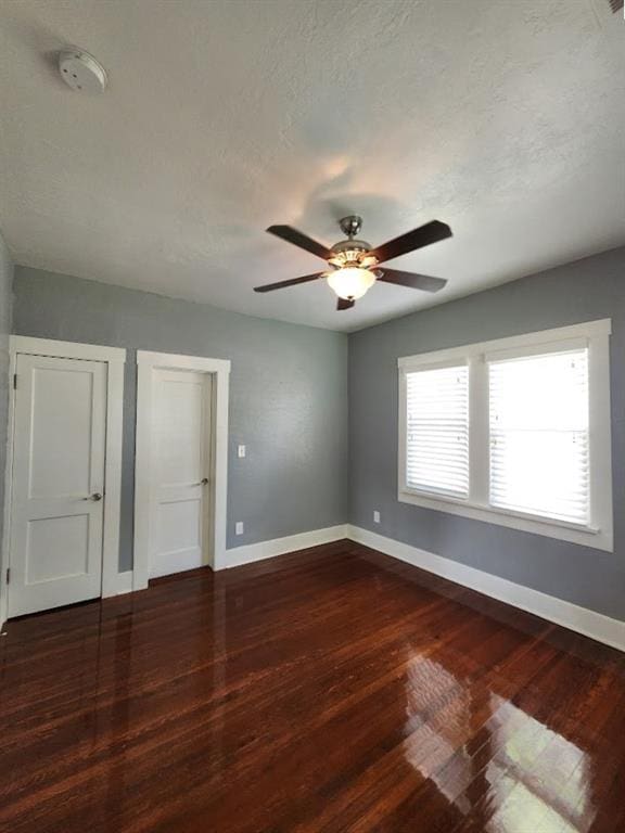 2719 NW 14th St, Oklahoma City, OK 73107 - unfurnished bedroom featuring dark wood-type flooring and ceiling fan