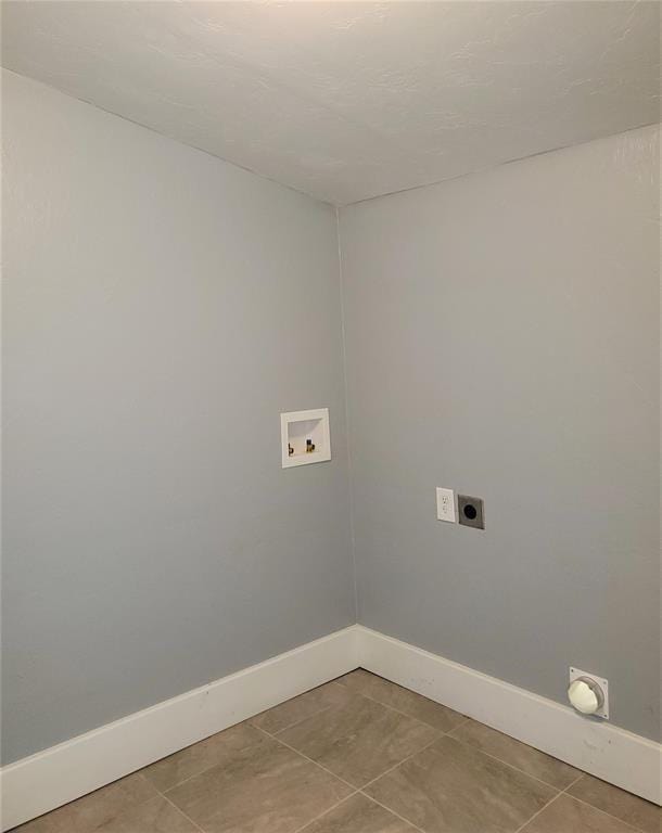 2719 NW 14th St, Oklahoma City, OK 73107 - laundry area with hookup for an electric dryer, washer hookup, and light tile patterned floors