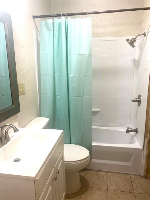 6101 S Douglas Ave, Oklahoma City, OK 73139 - bathroom featuring vanity, shower / bathtub combination with curtain, tile patterned flooring, and a textured wall