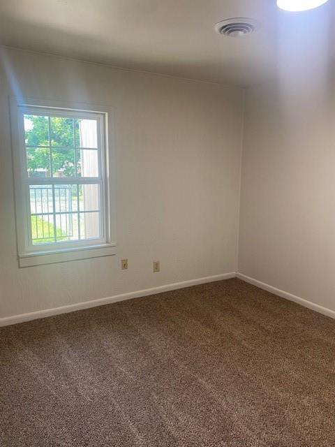 6101 S Douglas Ave, Oklahoma City, OK 73139 - carpeted empty room featuring baseboards