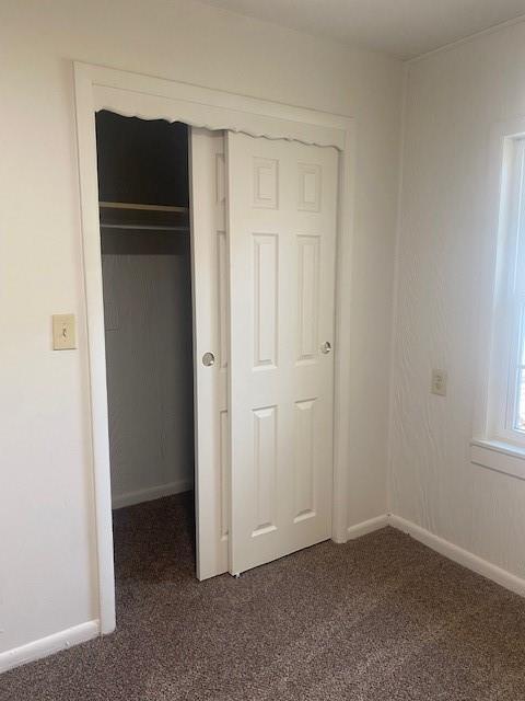 6101 S Douglas Ave, Oklahoma City, OK 73139 - unfurnished bedroom with dark carpet and a closet