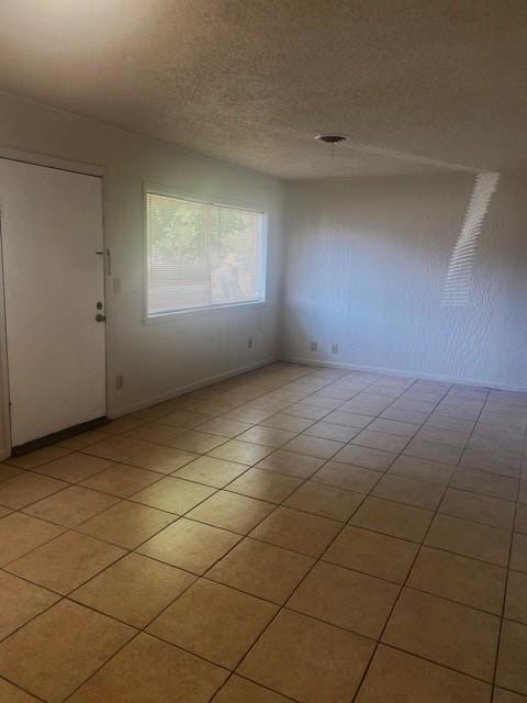 6101 S Douglas Ave, Oklahoma City, OK 73139 - spare room with light tile patterned floors and a textured ceiling