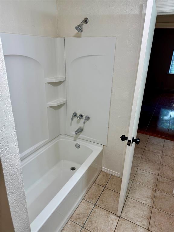 6101 S Douglas Ave, Oklahoma City, OK 73139 - full bathroom featuring tile patterned floors and shower / bathtub combination