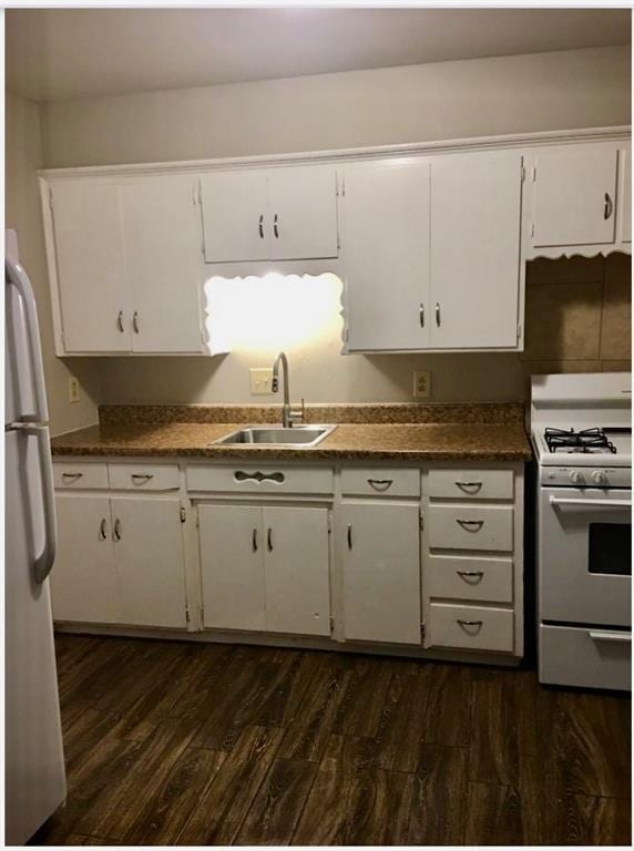 6101 S Douglas Ave, Oklahoma City, OK 73139 - kitchen with white appliances, white cabinetry, dark wood-type flooring, and dark countertops