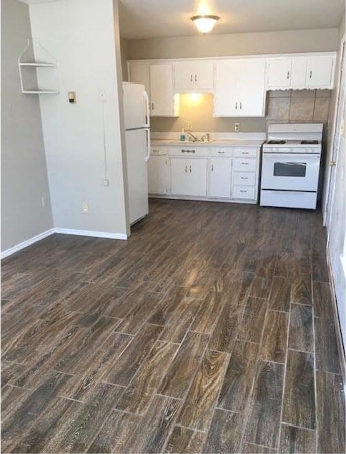 6101 S Douglas Ave, Oklahoma City, OK 73139 - kitchen featuring white appliances, dark wood-style floors, and white cabinets