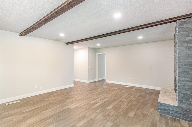 1004 Ranchoak Ct, Yukon, OK 73099 - basement featuring light wood-type flooring, a textured ceiling, and recessed lighting