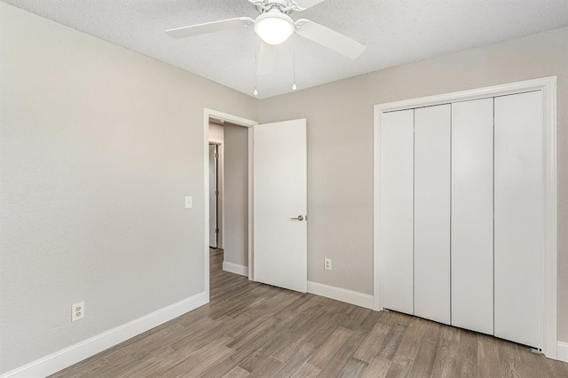 1004 Ranchoak Ct, Yukon, OK 73099 - unfurnished bedroom with wood finished floors, a closet, and ceiling fan