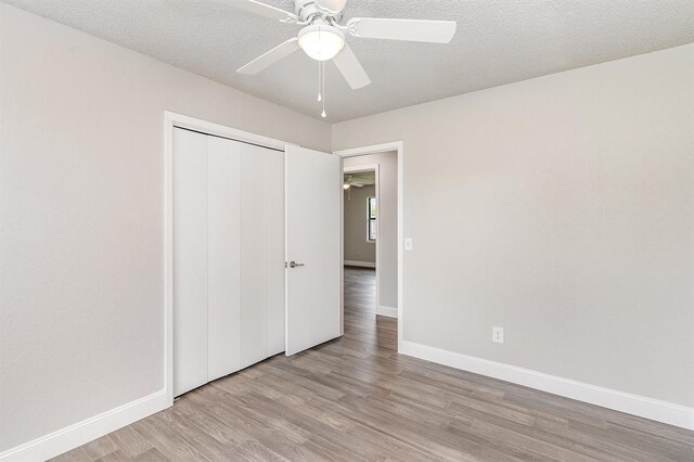1004 Ranchoak Ct, Yukon, OK 73099 - unfurnished bedroom featuring wood finished floors, a closet, and a ceiling fan