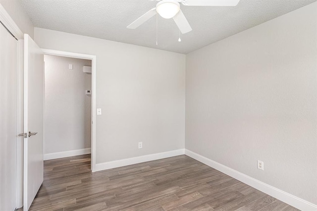 1004 Ranchoak Ct, Yukon, OK 73099 - spare room featuring wood finished floors, ceiling fan, and a textured ceiling