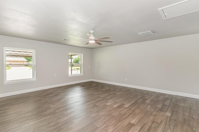 1004 Ranchoak Ct, Yukon, OK 73099 - spare room with attic access, dark wood-style floors, and ceiling fan