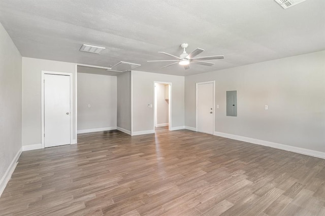 1004 Ranchoak Ct, Yukon, OK 73099 - spare room with attic access, electric panel, a ceiling fan, and wood finished floors