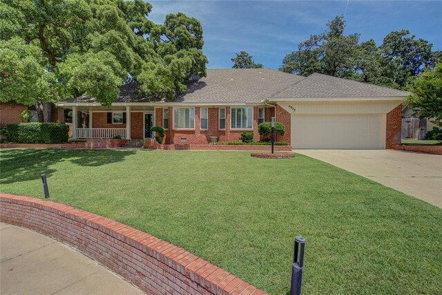4973 NW 31st Ter, Oklahoma City, OK 73122 - ranch-style house with an attached garage, concrete driveway, covered porch, a front lawn, and brick siding