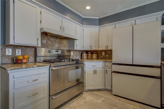 4973 NW 31st Ter, Oklahoma City, OK 73122 - kitchen with range with two ovens, high end fridge, light stone countertops, ornamental molding, and under cabinet range hood