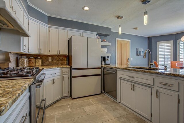 4973 NW 31st Ter, Oklahoma City, OK 73122 - kitchen featuring appliances with stainless steel finishes, under cabinet range hood, decorative backsplash, crown molding, and decorative light fixtures