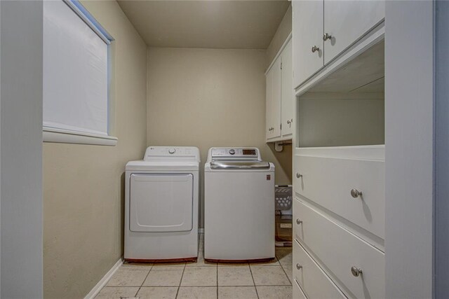 4973 NW 31st Ter, Oklahoma City, OK 73122 - washroom with washer and clothes dryer, cabinet space, and light tile patterned floors