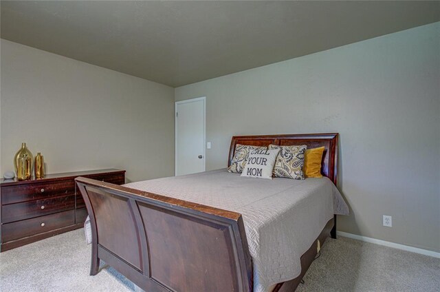 4973 NW 31st Ter, Oklahoma City, OK 73122 - bedroom featuring light carpet and baseboards