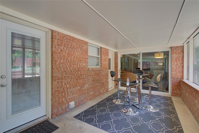 4973 NW 31st Ter, Oklahoma City, OK 73122 - sunroom / solarium featuring brick wall and concrete flooring