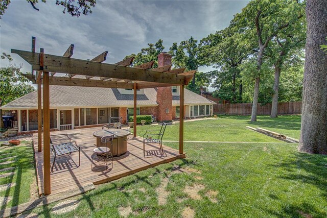 4973 NW 31st Ter, Oklahoma City, OK 73122 - view of yard with a wooden deck, an outdoor fire pit, and a sunroom