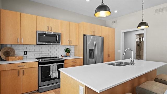 627 Couch Dr Unit S05, Oklahoma City, OK 73102 - kitchen with appliances with stainless steel finishes, decorative backsplash, light countertops, a kitchen breakfast bar, and decorative light fixtures
