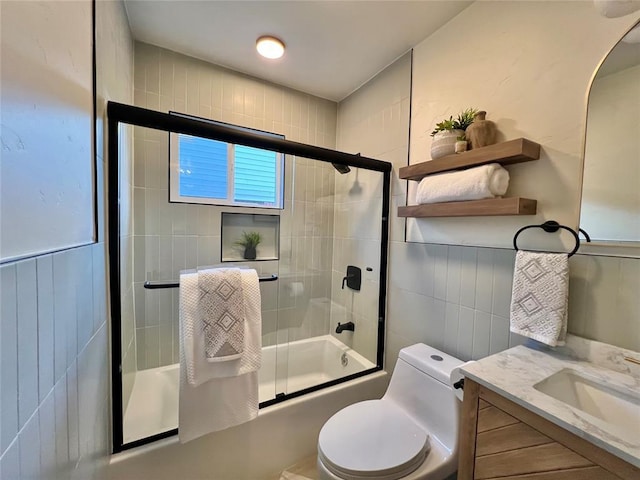 2332 NW 31st St, Oklahoma City, OK 73112 - bathroom featuring shower / bath combination with glass door, vanity, and tile walls