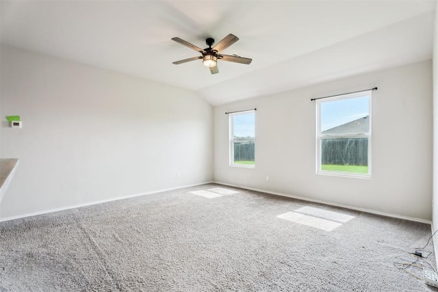 1016 N Deer Court Way, Mustang, OK 73064 - spare room featuring a ceiling fan, carpet, and lofted ceiling