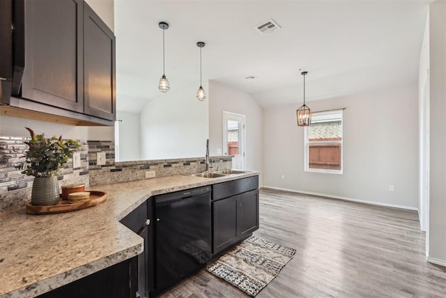 1016 N Deer Court Way, Mustang, OK 73064 - kitchen with dishwasher, tasteful backsplash, a peninsula, vaulted ceiling, and light wood-type flooring