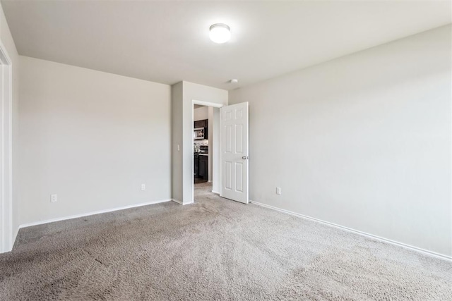 1016 N Deer Court Way, Mustang, OK 73064 - spare room featuring baseboards and carpet flooring