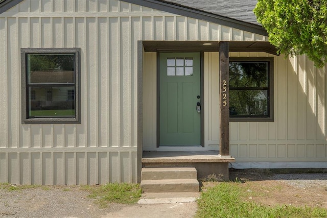 2325 SW Binkley St, Oklahoma City, OK 73119 - doorway to property featuring board and batten siding and a shingled roof