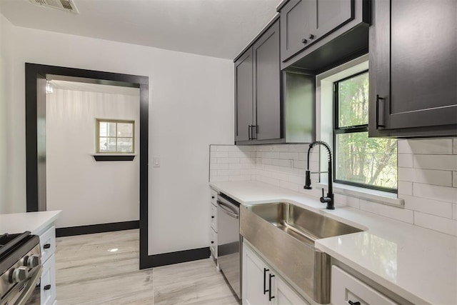 2325 SW Binkley St, Oklahoma City, OK 73119 - kitchen featuring light countertops, stainless steel appliances, and tasteful backsplash