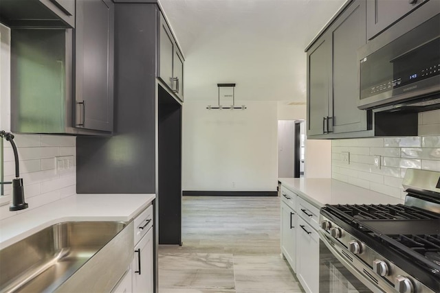 2325 SW Binkley St, Oklahoma City, OK 73119 - kitchen featuring appliances with stainless steel finishes, backsplash, and light countertops