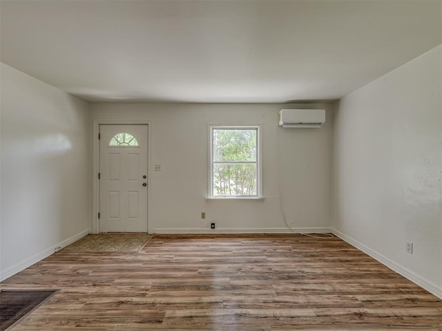 7235 SE 15th St, Midwest City, OK 73110 - foyer entrance with wood finished floors and an AC wall unit