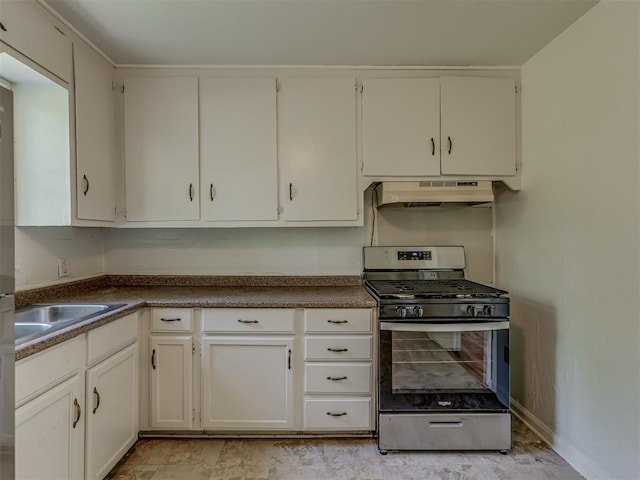7235 SE 15th St, Midwest City, OK 73110 - kitchen with stainless steel gas range, under cabinet range hood, dark countertops, and white cabinetry