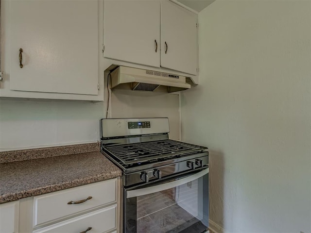 7235 SE 15th St, Midwest City, OK 73110 - kitchen featuring stainless steel range with gas stovetop, under cabinet range hood, white cabinets, and dark countertops
