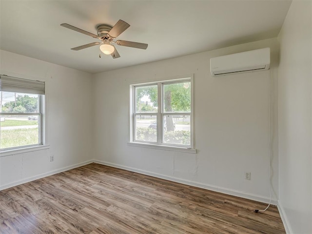 7235 SE 15th St, Midwest City, OK 73110 - empty room with a wall unit AC, wood finished floors, and ceiling fan