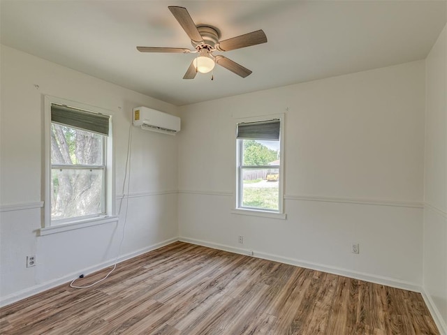 7235 SE 15th St, Midwest City, OK 73110 - empty room with a wall unit AC, wood finished floors, and ceiling fan
