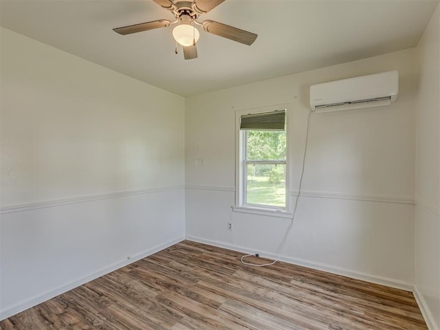 7235 SE 15th St, Midwest City, OK 73110 - empty room featuring a wall mounted air conditioner, wood finished floors, and a ceiling fan