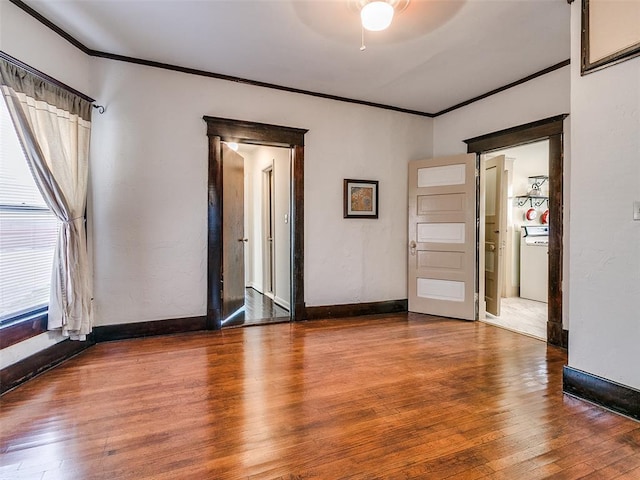 312 NW 24th St, Oklahoma City, OK 73103 - unfurnished room with ornamental molding, wood-type flooring, washer / clothes dryer, and a ceiling fan