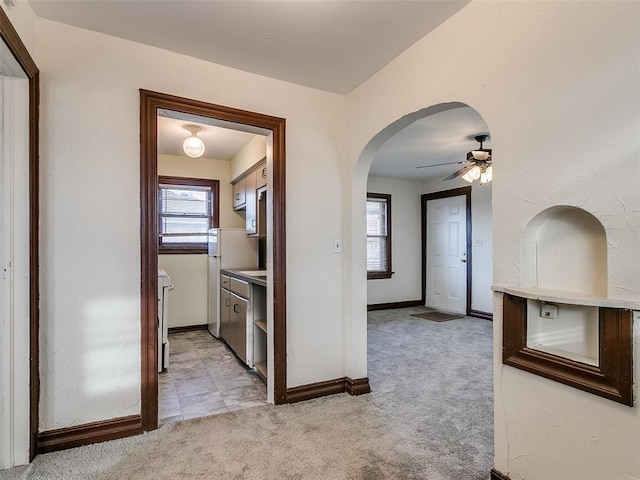 312 NW 24th St, Oklahoma City, OK 73103 - hall with arched walkways, light carpet, and plenty of natural light