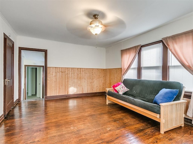 312 NW 24th St, Oklahoma City, OK 73103 - living area with ceiling fan, wood finished floors, crown molding, wooden walls, and wainscoting