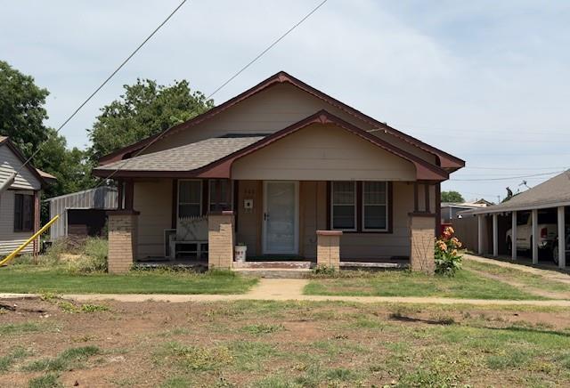 bungalow-style home with a porch and a front yard