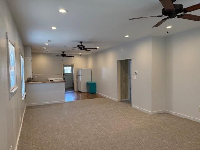 unfurnished room with carpet flooring, a ceiling fan, and recessed lighting