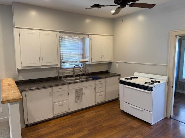 kitchen featuring white gas range, ceiling fan, dark countertops, white cabinetry, and recessed lighting