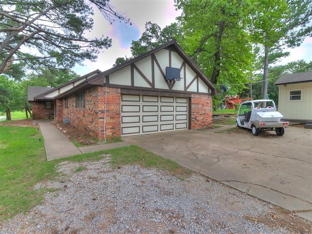 3908 Southwestern Ave, Edmond, OK 73034 - view of side of home featuring brick siding, driveway, and an attached garage