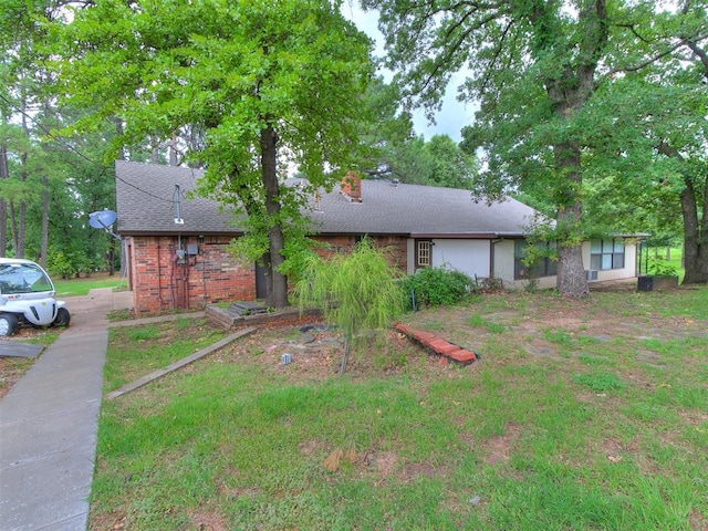 3908 Southwestern Ave, Edmond, OK 73034 - view of front of property featuring a chimney, a shingled roof, and brick siding