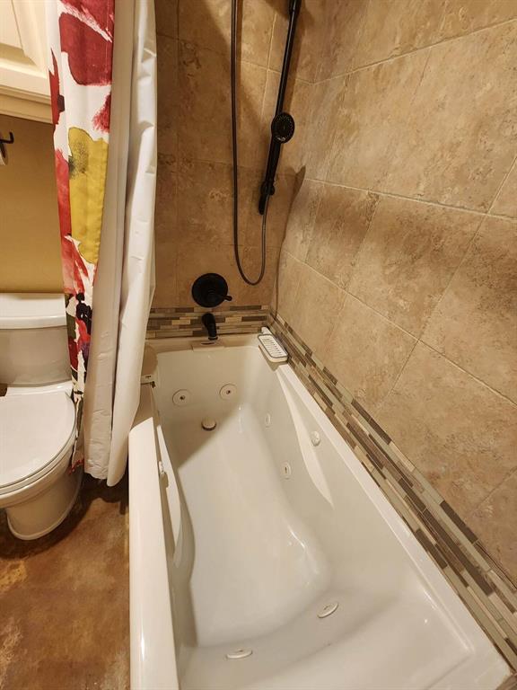 3908 Southwestern Ave, Edmond, OK 73034 - full bathroom featuring a combined bath / shower with jetted tub and toilet