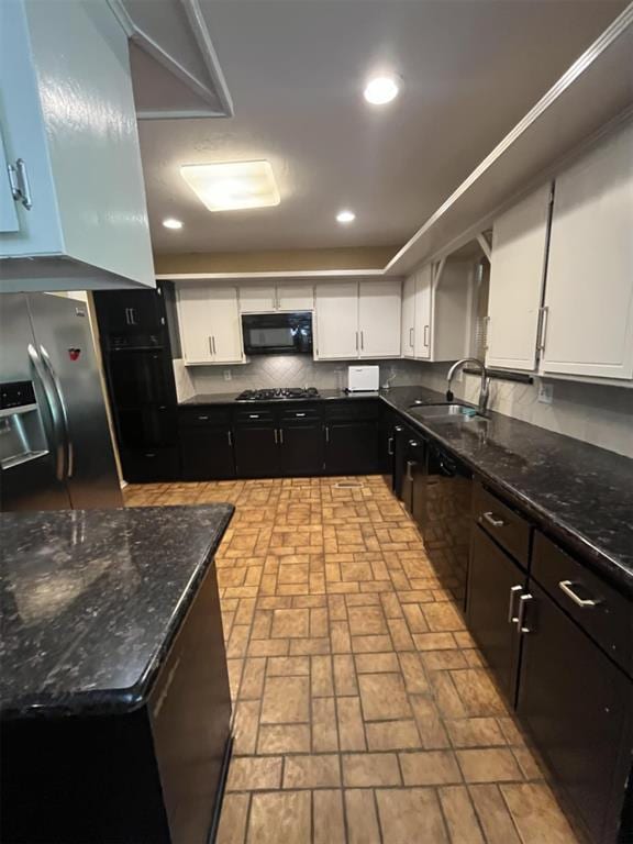 3908 Southwestern Ave, Edmond, OK 73034 - kitchen featuring black appliances, white cabinets, brick patterned flooring, dark stone counters, and recessed lighting