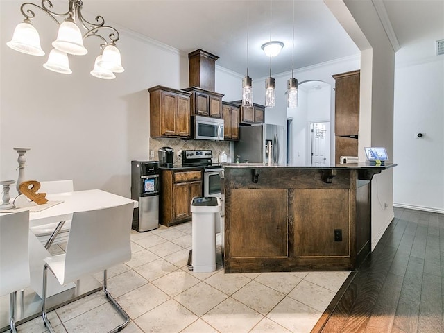 19940 Vivace Ct, Edmond, OK 73013 - kitchen with appliances with stainless steel finishes, ornamental molding, tasteful backsplash, a chandelier, and pendant lighting