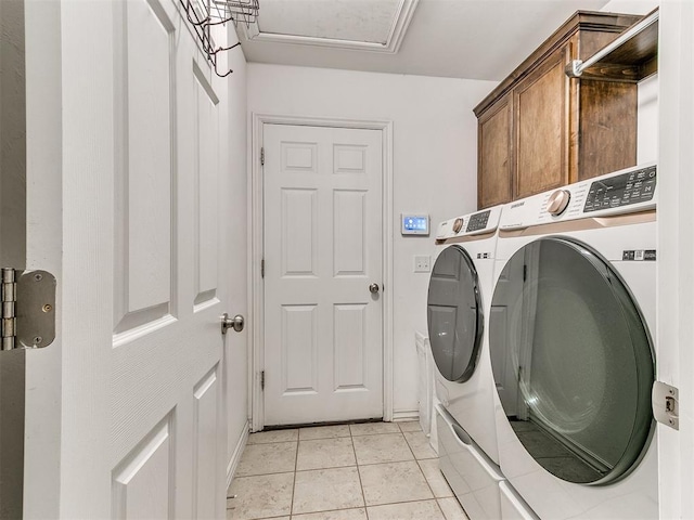 19940 Vivace Ct, Edmond, OK 73013 - washroom featuring washer and clothes dryer, cabinet space, and light tile patterned floors