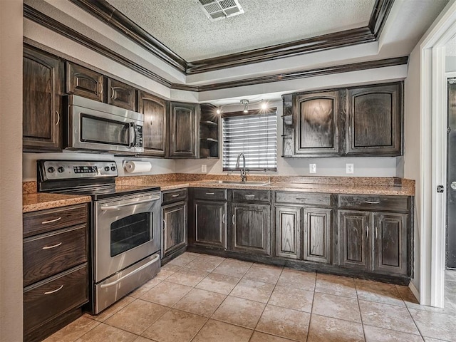 503 W Owens St, El Reno, OK 73036 - kitchen featuring appliances with stainless steel finishes, ornamental molding, a textured ceiling, dark brown cabinets, and open shelves